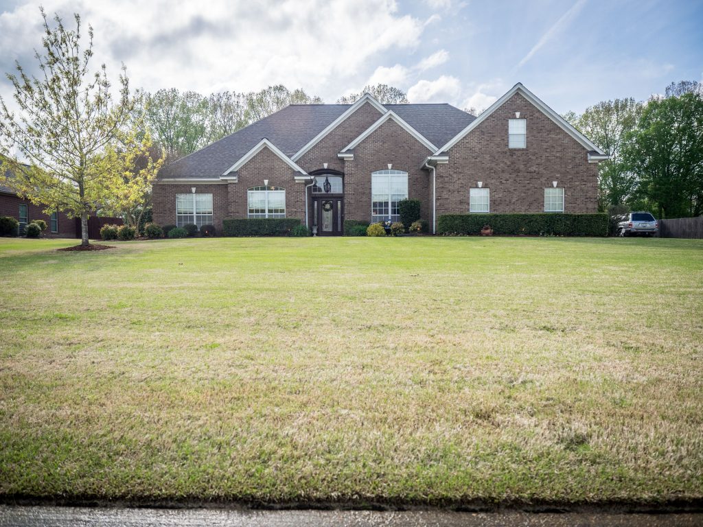 Before and after complete home renovation in Tupelo MS showcasing a modern exterior and interior overhaul.