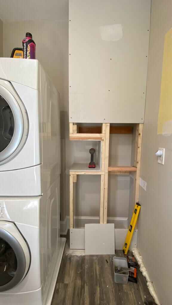 Laundry room renovation in progress — cabinetry and plumbing installation by Galvez