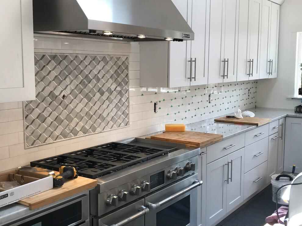 Modern tile backsplash design behind kitchen countertop